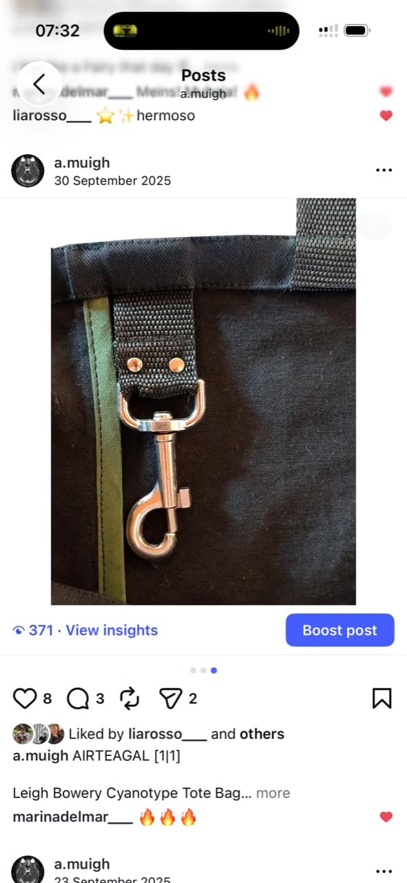 Screenshot showing a black tote bag strap and silver clip hardware
